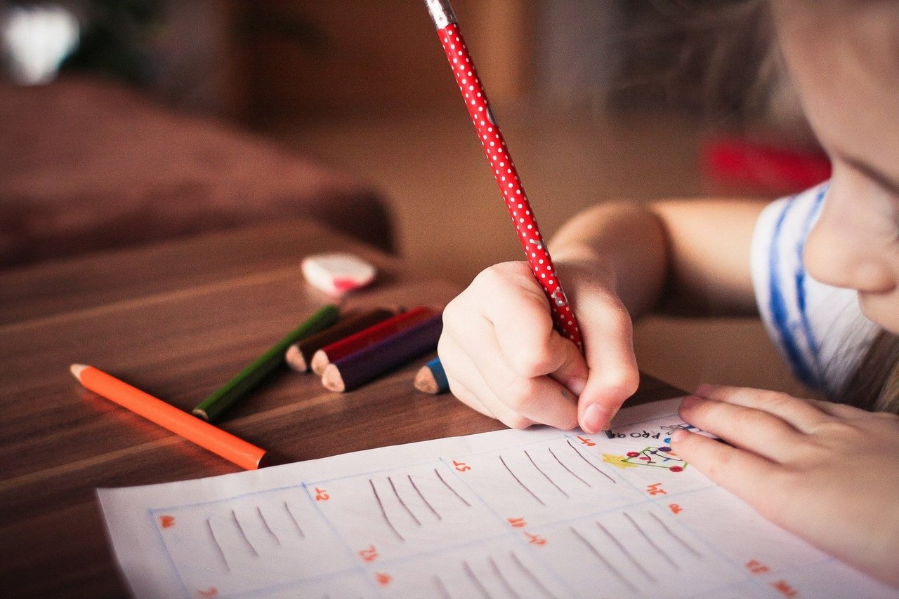 Child writes with pen