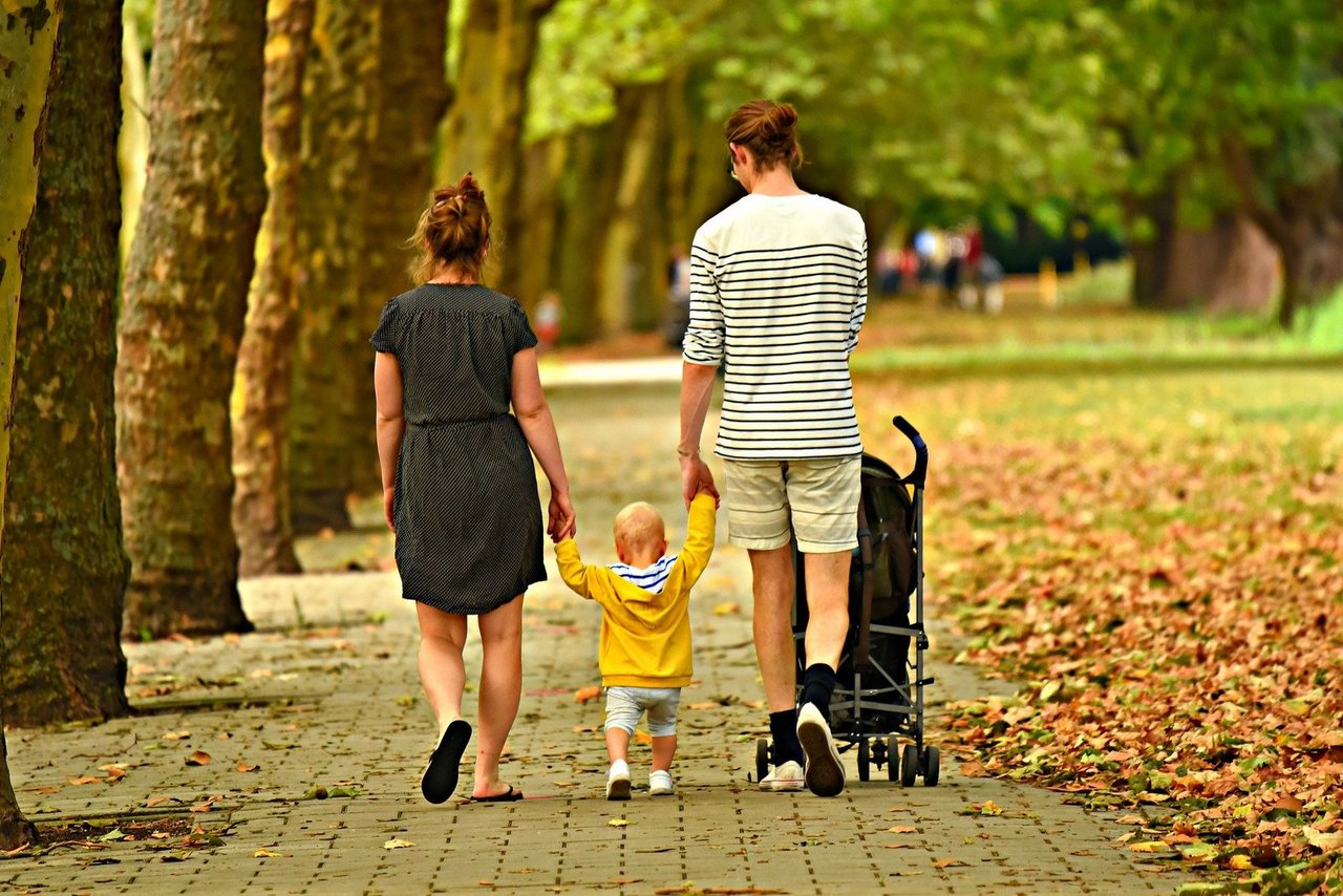  Parents with child walk in the forest