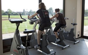 Two people doing indoor cycling