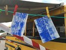Einsatz auf dem Hoffest beim Sonnenhof e.V. – Erste Druckergebnisse An einer Wäscheleine sind bedruckte Papierbögen zum trocknen aufgehangen.