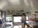 Sommerakademie Design & Kunst 2019 – Blick in den MO•KU•LAB Ausstellungsraum Ein Mädchen steht im Bus und um Sie herum sind Fotografien aufgehängt.