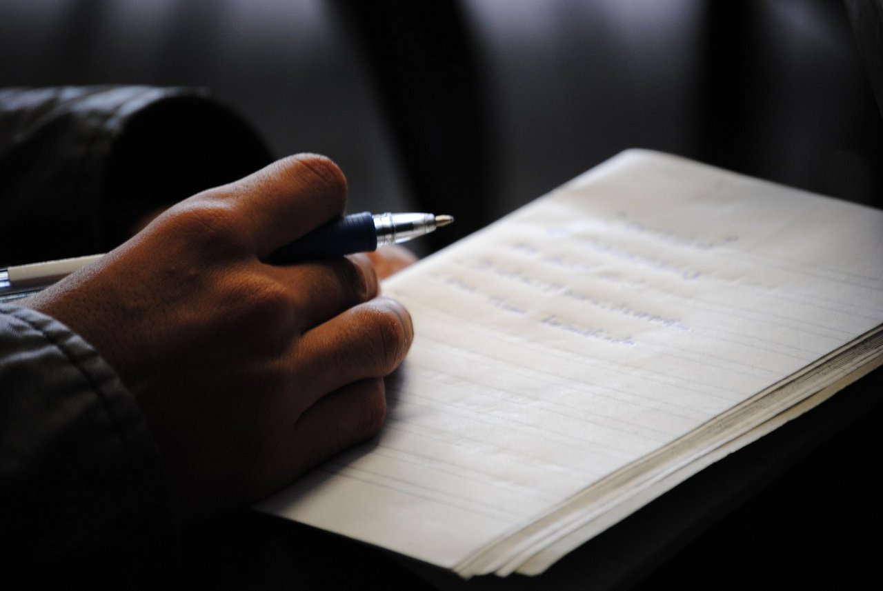  Hand with pen and notebook