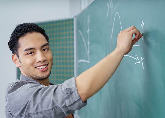 a person writes on a board